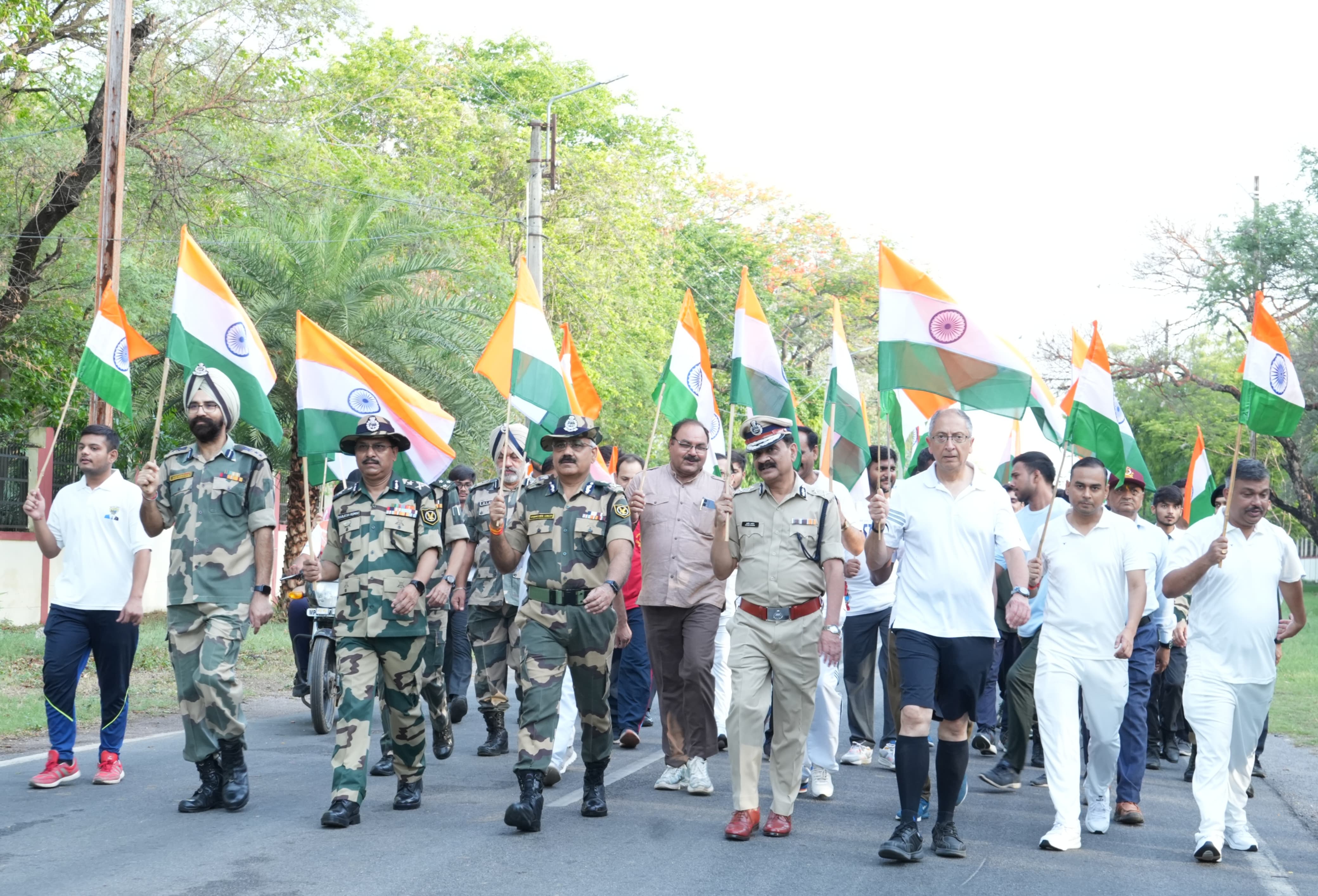 Shri Cyrus Rustamji and ADG Dr. Shamsher Singh, IPS (Vice Chairman, RJIT), leading the Tiranga Yatra with BSF officers and RJIT family.